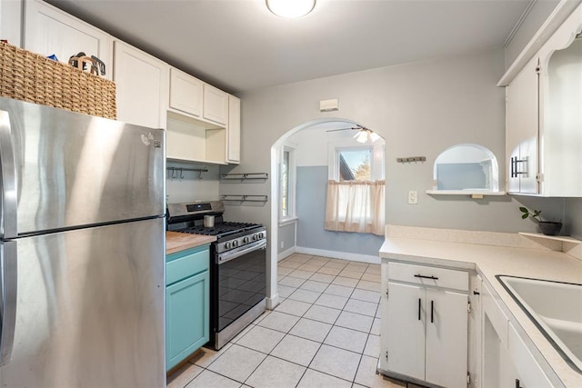 kitchen featuring white cabinetry, appliances with stainless steel finishes, sink, and light tile patterned floors