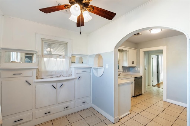 kitchen featuring white cabinetry, light tile patterned floors, and dishwasher