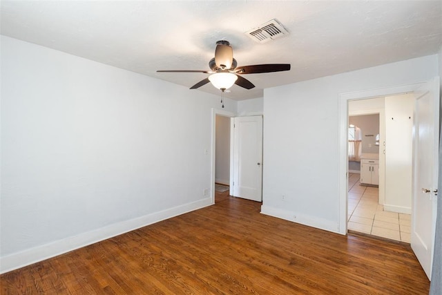 spare room with wood-type flooring and ceiling fan