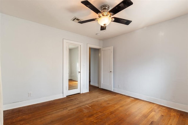 unfurnished bedroom with ceiling fan and wood-type flooring