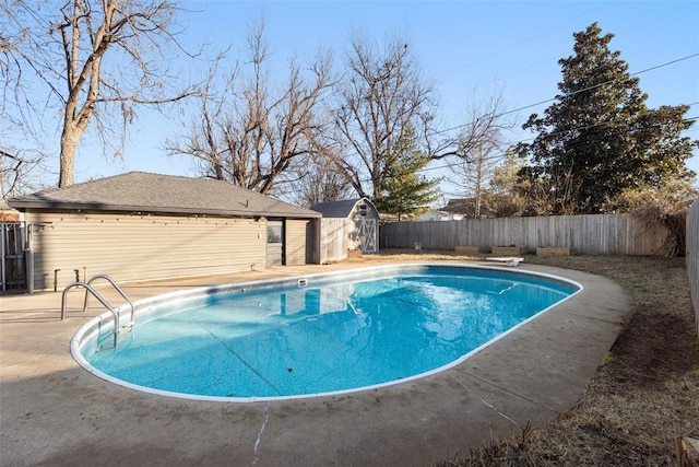 view of pool featuring a storage unit, a diving board, and a patio area