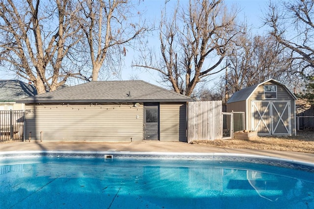 view of pool with a storage shed