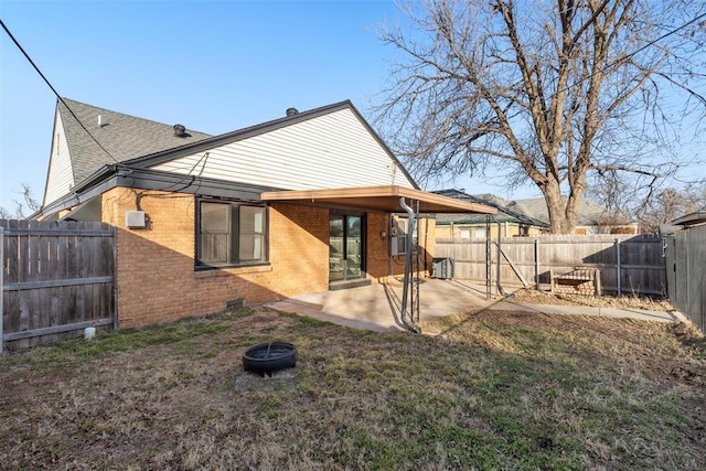 rear view of house featuring central AC unit, a patio area, and a lawn