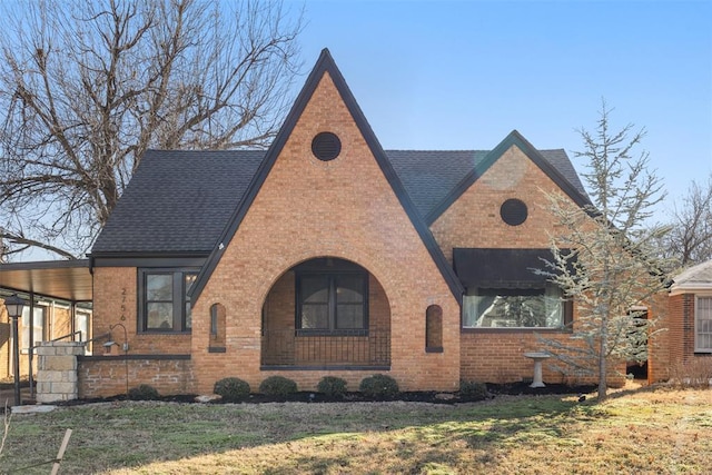 tudor home featuring a front lawn