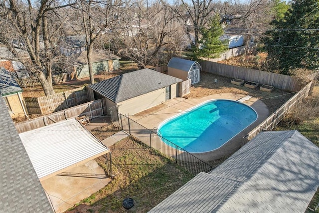 view of pool with a shed