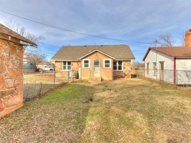 rear view of house featuring a lawn