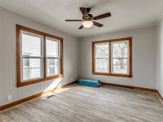 unfurnished room featuring crown molding, ceiling fan, and light hardwood / wood-style flooring