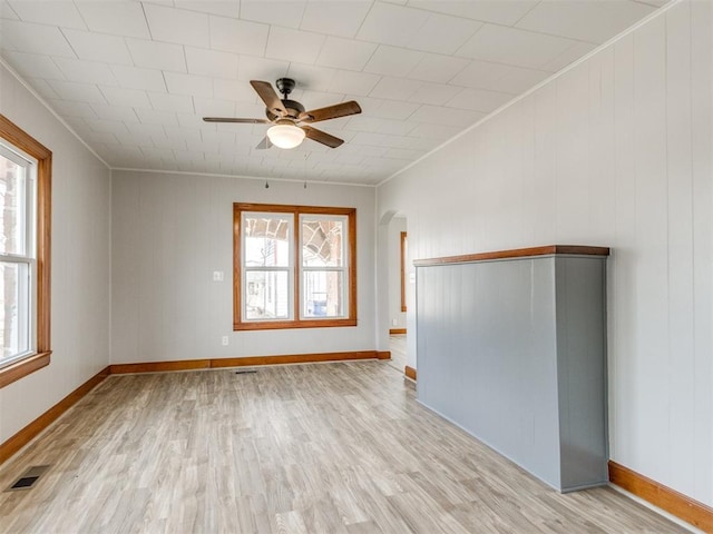 spare room featuring ceiling fan, ornamental molding, and light hardwood / wood-style floors