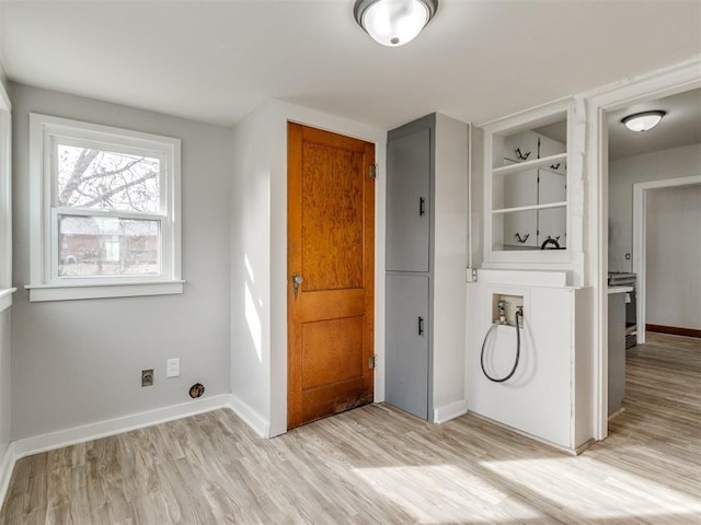 washroom featuring washer hookup and light hardwood / wood-style flooring