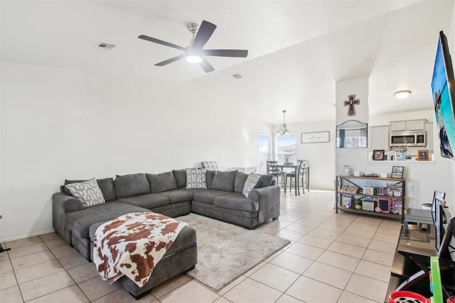 tiled living room with lofted ceiling and ceiling fan