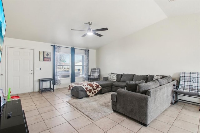 living room with ceiling fan, lofted ceiling, and light tile patterned floors