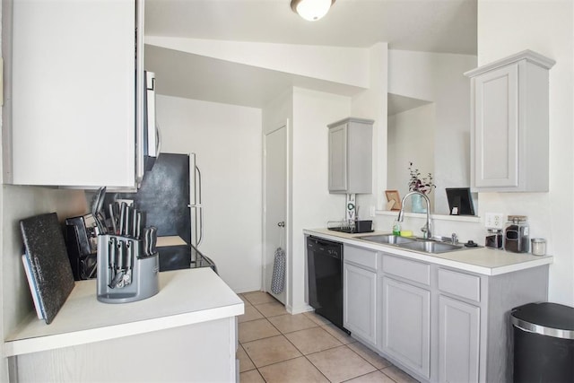 kitchen featuring sink, light tile patterned floors, gray cabinets, and black dishwasher