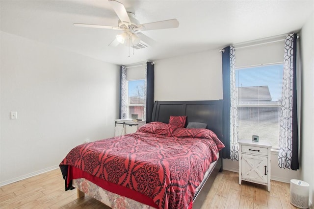 bedroom with ceiling fan and light hardwood / wood-style floors