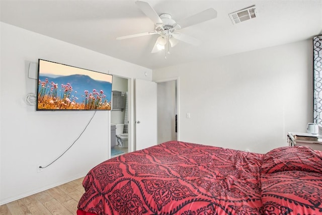 bedroom with ceiling fan, light hardwood / wood-style floors, and ensuite bath