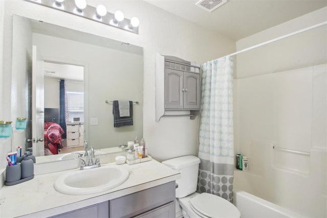 full bathroom featuring vanity, toilet, and shower / bath combo with shower curtain