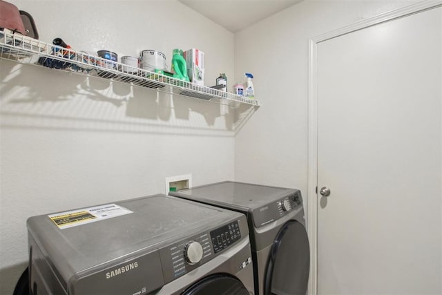 clothes washing area featuring washer and clothes dryer