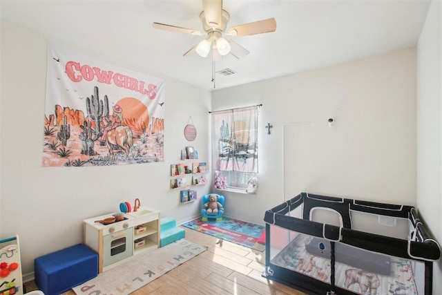 rec room featuring wood-type flooring and ceiling fan