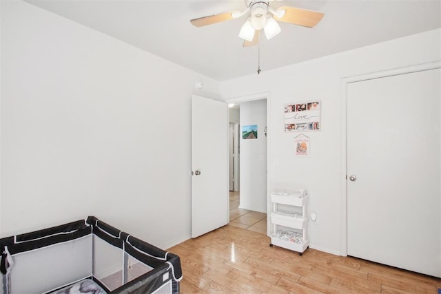 bedroom with light hardwood / wood-style floors and ceiling fan