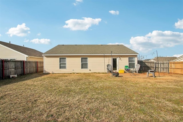 rear view of property featuring a lawn and a patio