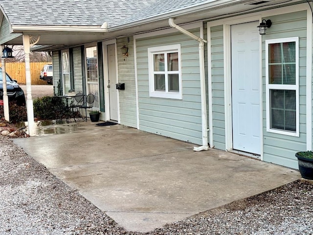 view of patio featuring covered porch and fence