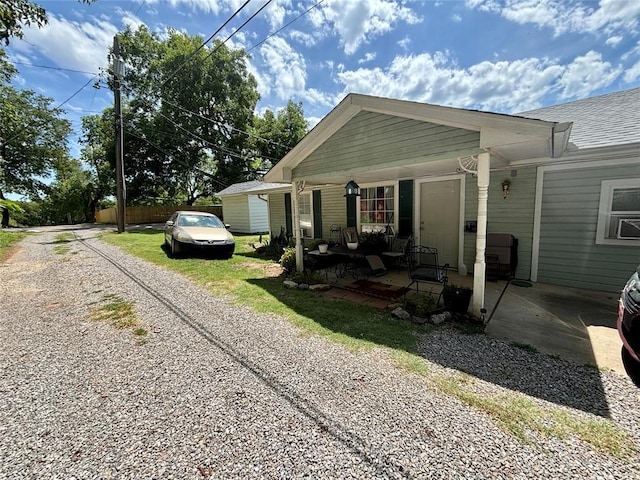 view of front facade with roof with shingles and driveway