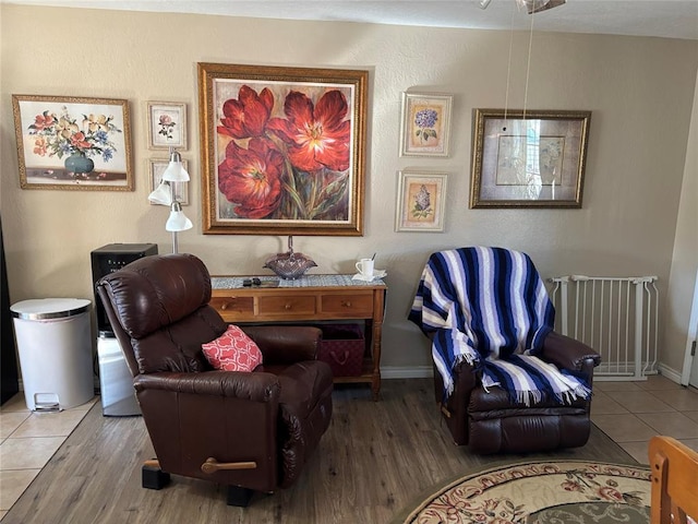 sitting room featuring baseboards and wood finished floors