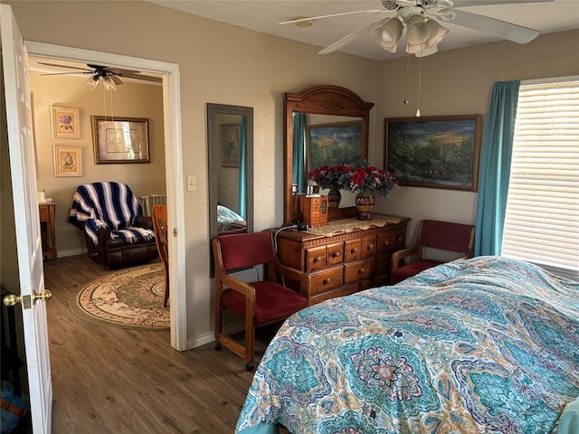 bedroom with baseboards, a ceiling fan, and wood finished floors