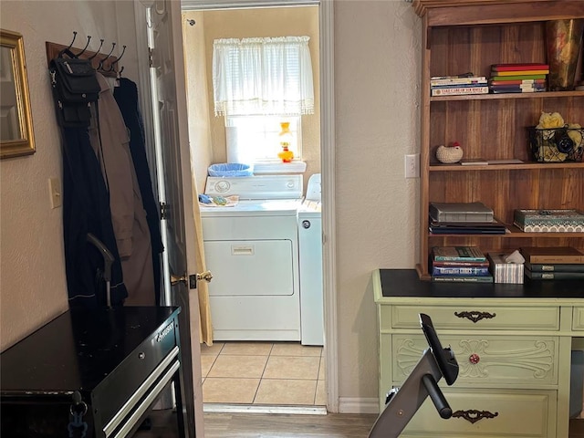 washroom with light tile patterned floors, laundry area, and independent washer and dryer