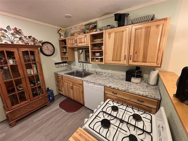 kitchen with white appliances, a sink, light wood-style floors, ornamental molding, and open shelves