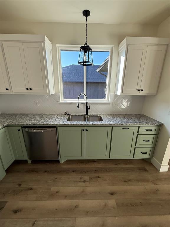 kitchen with dishwasher, sink, white cabinets, green cabinets, and light hardwood / wood-style floors