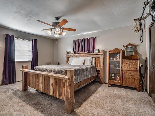 bedroom featuring ceiling fan, carpet flooring, and a textured ceiling