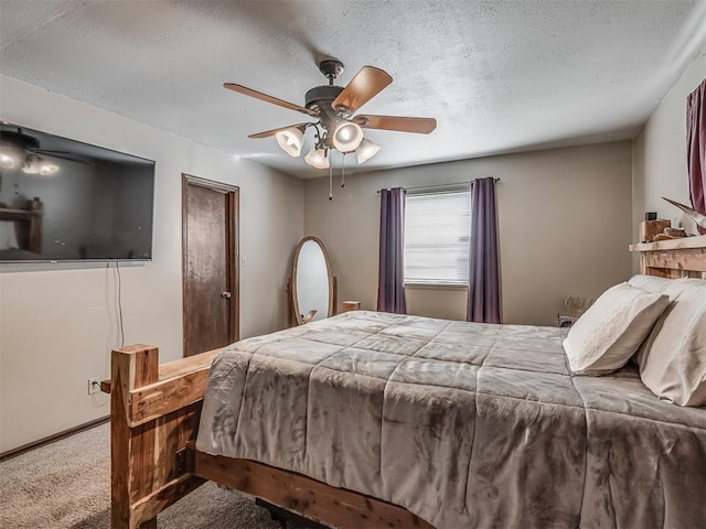 bedroom featuring ceiling fan, carpet floors, and a textured ceiling