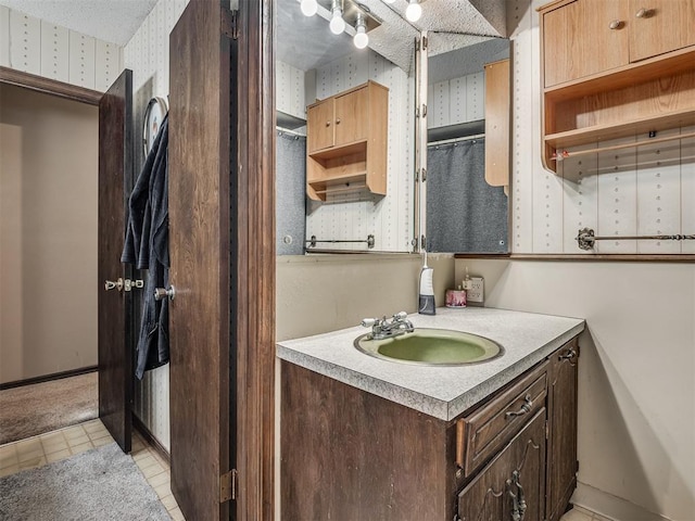 bathroom with vanity and a textured ceiling