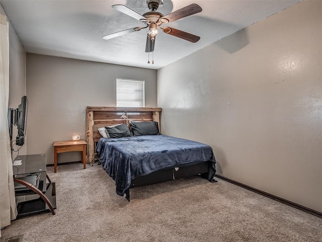 bedroom with a textured ceiling, ceiling fan, and carpet