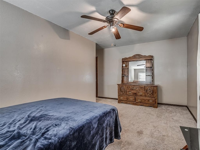 bedroom with ceiling fan and light carpet