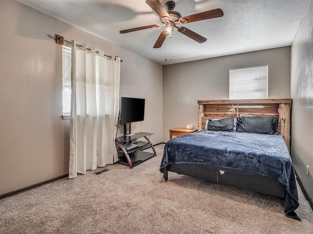 bedroom featuring carpet, a textured ceiling, and ceiling fan