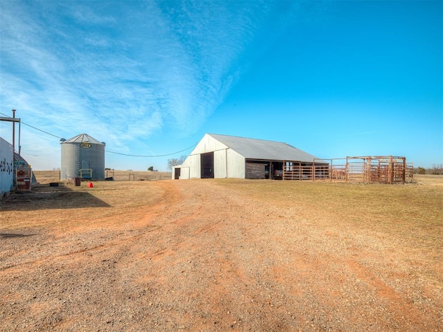 view of yard with a rural view and an outdoor structure