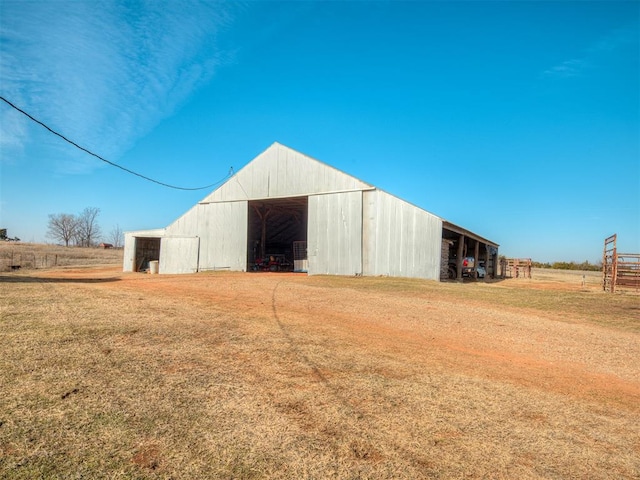 view of outbuilding featuring a lawn and a rural view