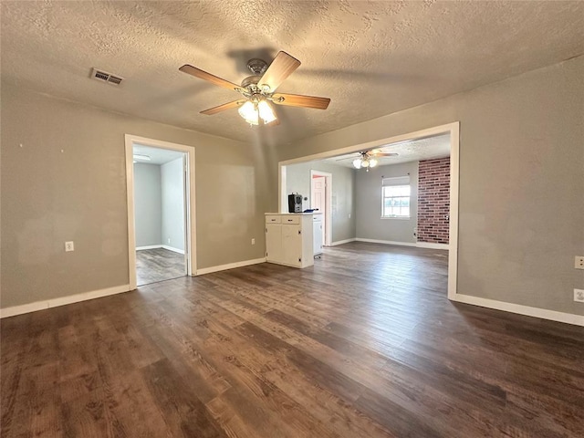 interior space featuring ceiling fan, dark hardwood / wood-style floors, and a textured ceiling