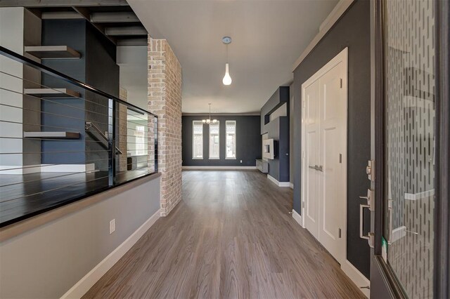 1548 NW 175th Ct, Edmond, OK 73012 - hallway with wood finished floors, stairs, baseboards, and a chandelier