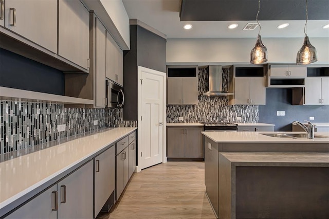 1548 NW 175th Ct, Edmond, OK 73012 - kitchen featuring wall chimney exhaust hood, stainless steel appliances, a sink, decorative light fixtures, and backsplash