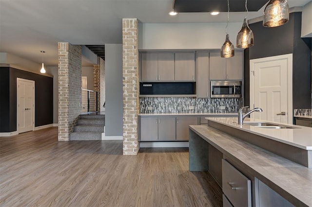 1548 NW 175th Ct, Edmond, OK 73012 - kitchen with stainless steel microwave, a sink, gray cabinetry, and pendant lighting
