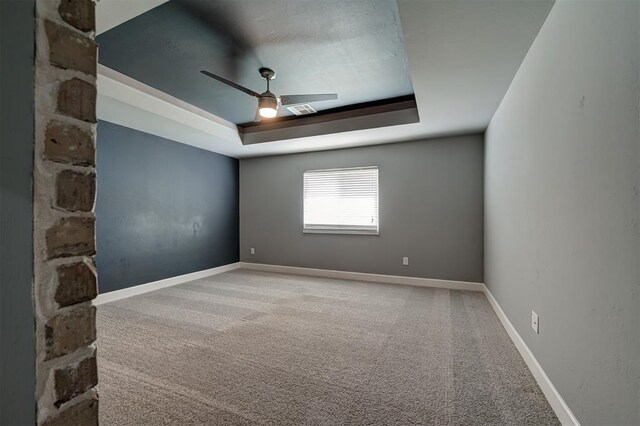 1548 NW 175th Ct, Edmond, OK 73012 - unfurnished room with a raised ceiling, carpet floors, ceiling fan, and baseboards