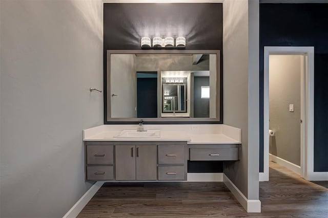 1548 NW 175th Ct, Edmond, OK 73012 - bathroom featuring wood finished floors, vanity, and baseboards