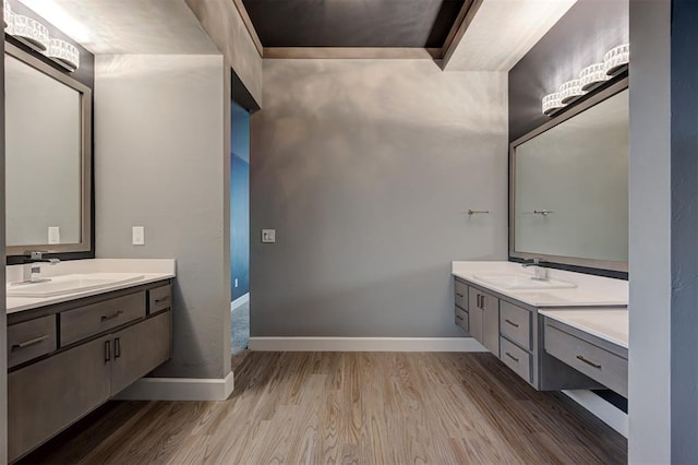 1548 NW 175th Ct, Edmond, OK 73012 - bathroom with wood finished floors, two vanities, and baseboards