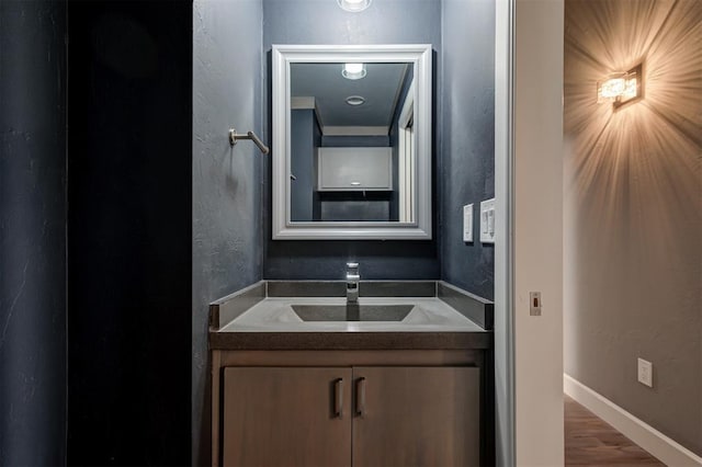 1548 NW 175th Ct, Edmond, OK 73012 - bathroom featuring vanity, wood finished floors, and baseboards