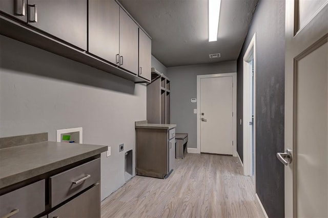 1548 NW 175th Ct, Edmond, OK 73012 - laundry area featuring cabinet space, hookup for an electric dryer, light wood-style floors, hookup for a washing machine, and baseboards