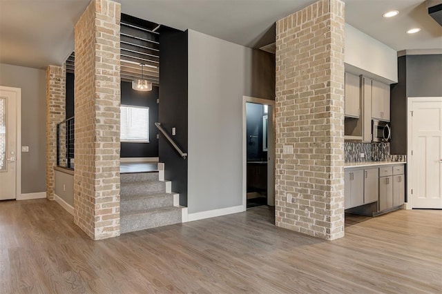 1548 NW 175th Ct, Edmond, OK 73012 - kitchen featuring stainless steel microwave, baseboards, light wood-style flooring, tasteful backsplash, and recessed lighting