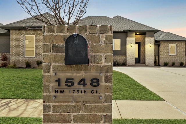 1548 NW 175th Ct, Edmond, OK 73012 - exterior view of brick siding, a shingled roof, and driveway