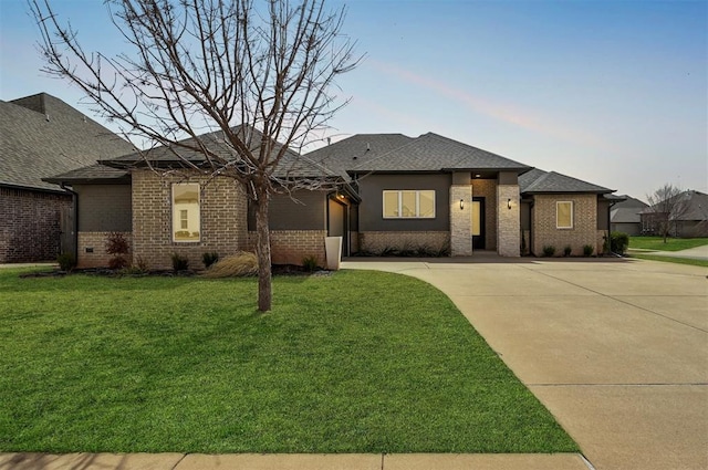 1548 NW 175th Ct, Edmond, OK 73012 - prairie-style house featuring concrete driveway, brick siding, a front yard, and a shingled roof